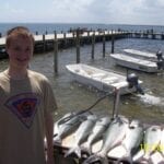 A man wearing a beige shirt near the fort