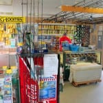 Interior of a colorful fishing tackle shop with various gear and accessories.