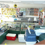 Interior of a fishing and tackle shop with coolers and gear.