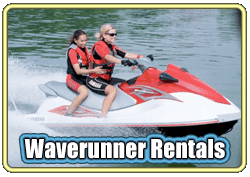 Two people riding a red waverunner on water, wearing life jackets.