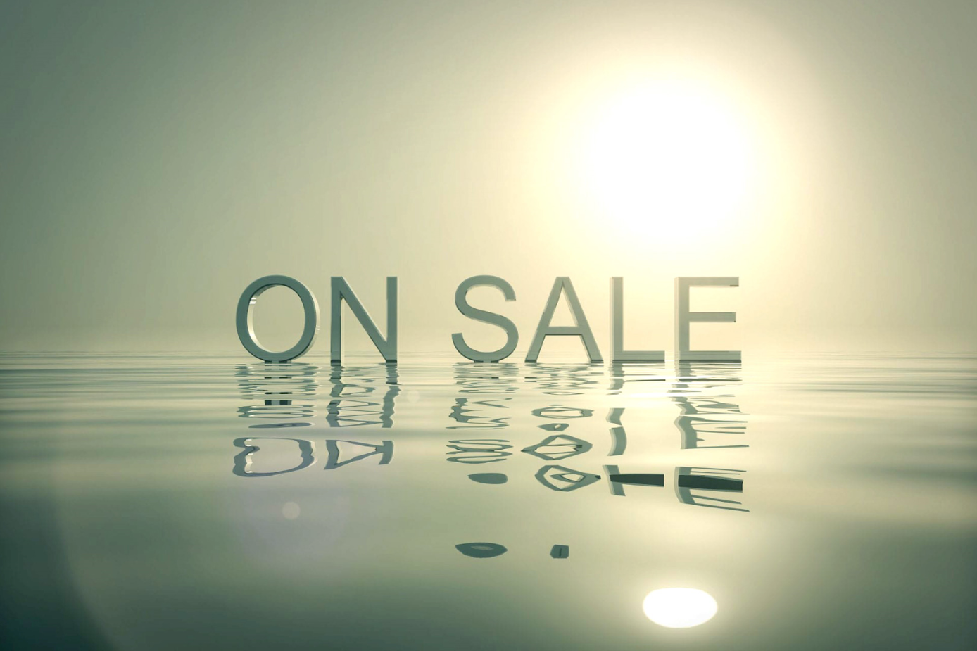The words 'ON SALE' reflected on calm water with a bright sun.