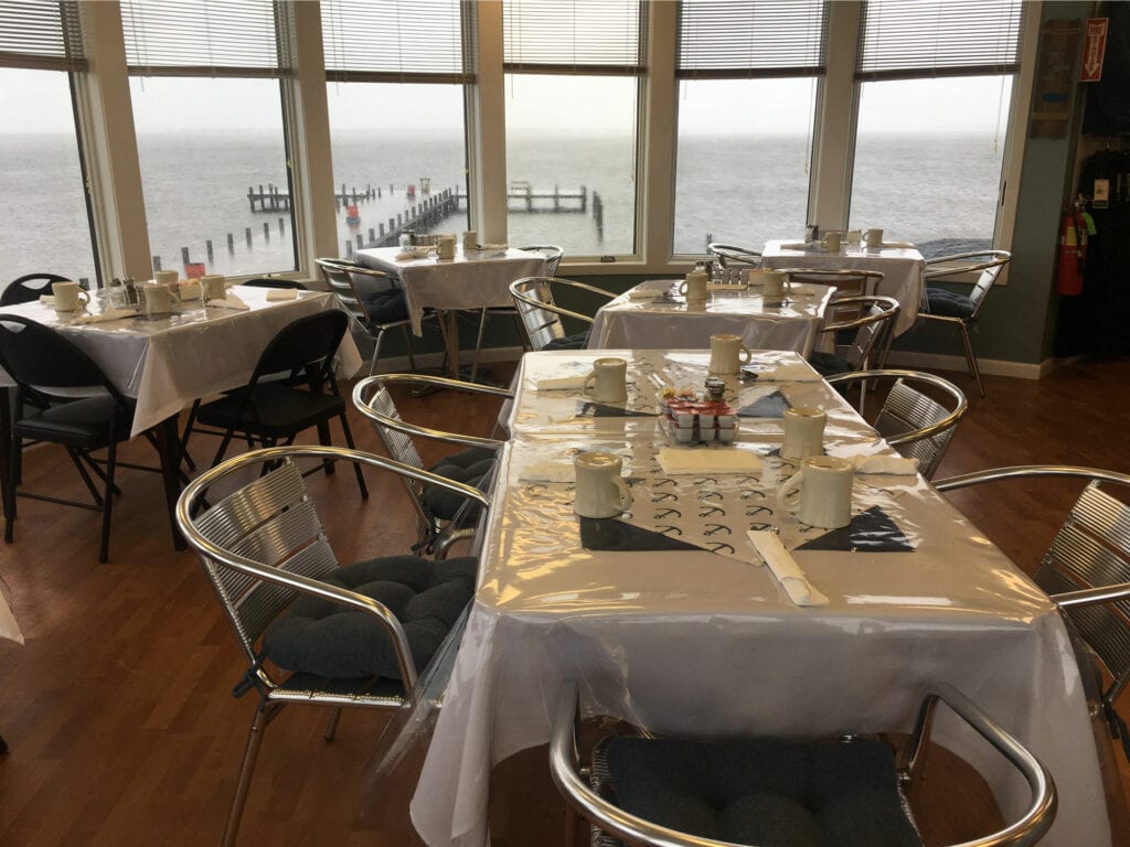 Five tables with white table cloths