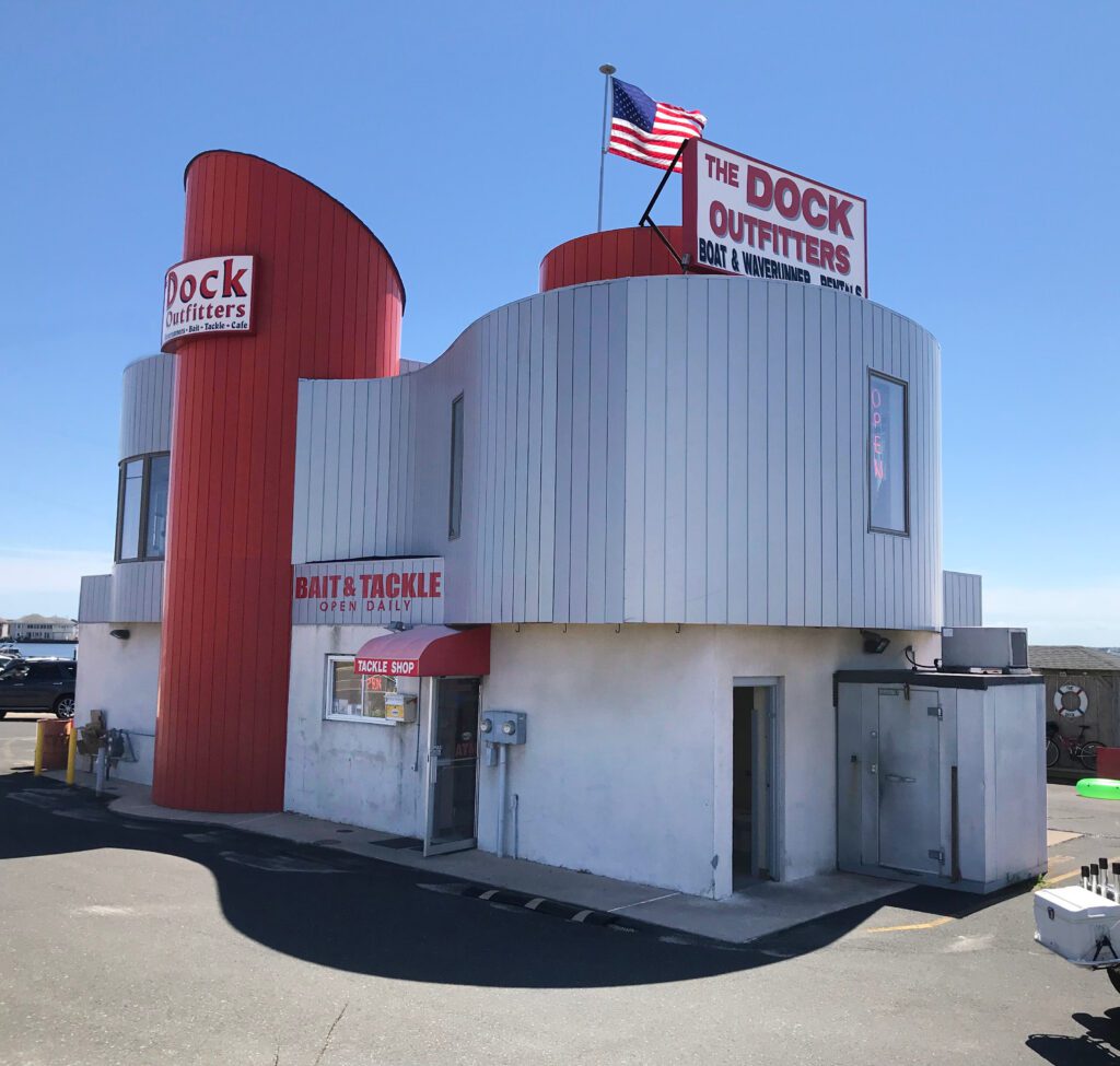 Unique round building with red tower and American flag on top.