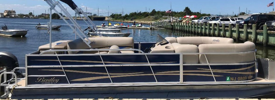 Luxury yachts docked in a peaceful marina under a clear sky.