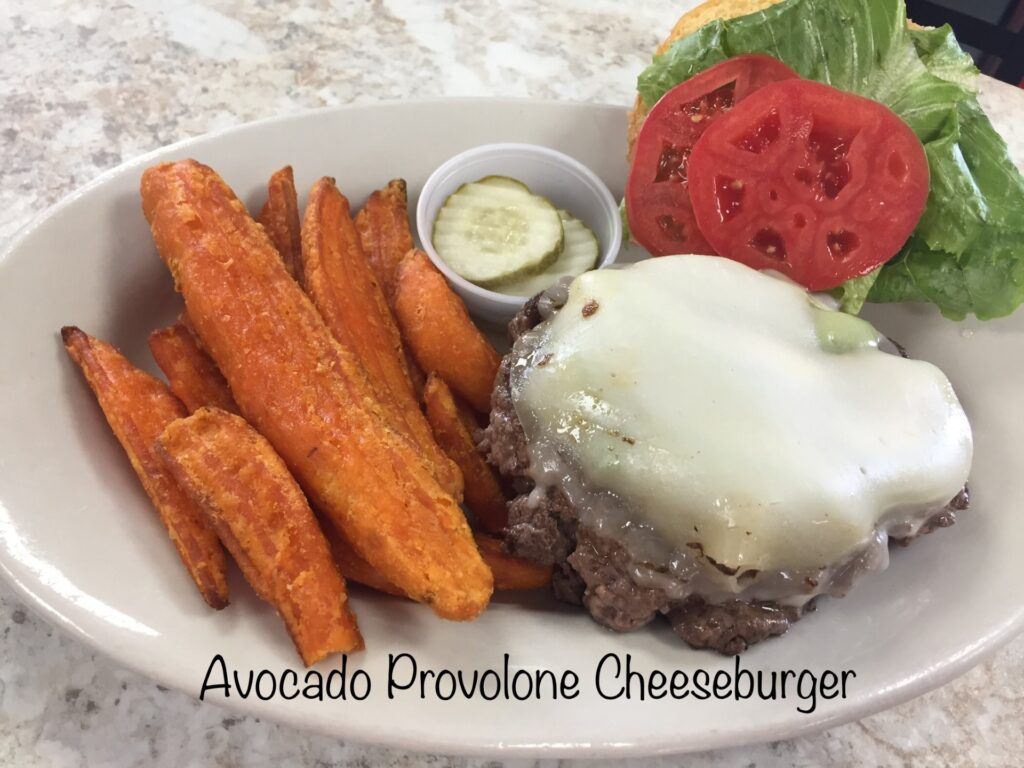Avocado Provolone Cheeseburger with sweet potato fries and dipping sauce.